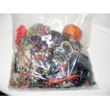 A large bag of costume jewellery, including bangles and necklaces