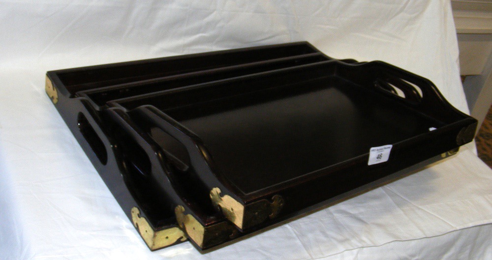 A set of three hardwood oriental serving trays