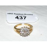 A diamond cluster ring in 18ct gold setting
