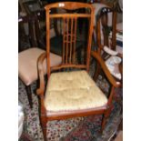 An Edwardian armchair, together with one other