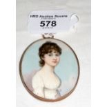 A Georgian miniature of lady in gold frame - 6cm - with hair to reverse