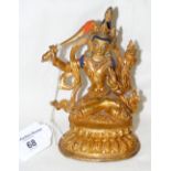 A gilt bronze deity figure with sword - 15cm high