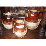 Three Doulton stoneware harvest jugs with silver rims