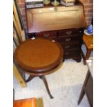 A bureau, together with a drum table