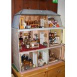 A large doll's house with extensive doll's house furniture