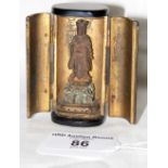 Small 7cm high black lacquer pocket shrine with hinged doors containing finely carved deity figure