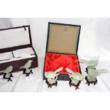 Jade carving of bird on carved wooden stand in original box, together with four others