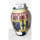 A small Moorcroft pottery vase with floral decoration - 11cm high - with mark to base