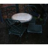 A heavy metal circular garden table and four chairs