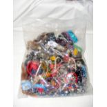 A large bag of costume jewellery, including bangles and necklaces