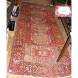 Middle Eastern rug with geometric border and centre medallions - 310cm x 120cm