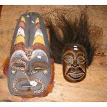 A Papua New Guinea carved wooden mask with shell work inlay - 69cm long, together with one other