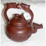 A yixing dragon teapot with signature to base and stylized handle - 21cm high
