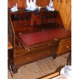 A Georgian mahogany bureau with fitted and inlaid interior, having two short and three long