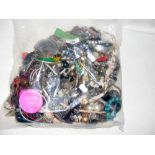 A large bag of costume jewellery, including bangles and necklaces