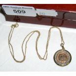 A gold coin in pendant mount with chain