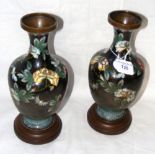 A pair of cloisonne vases with flower decoration on wooden stands - 25cm high