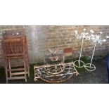 Wrought iron plant stand, two folding chairs and a pair of garden candelabra
