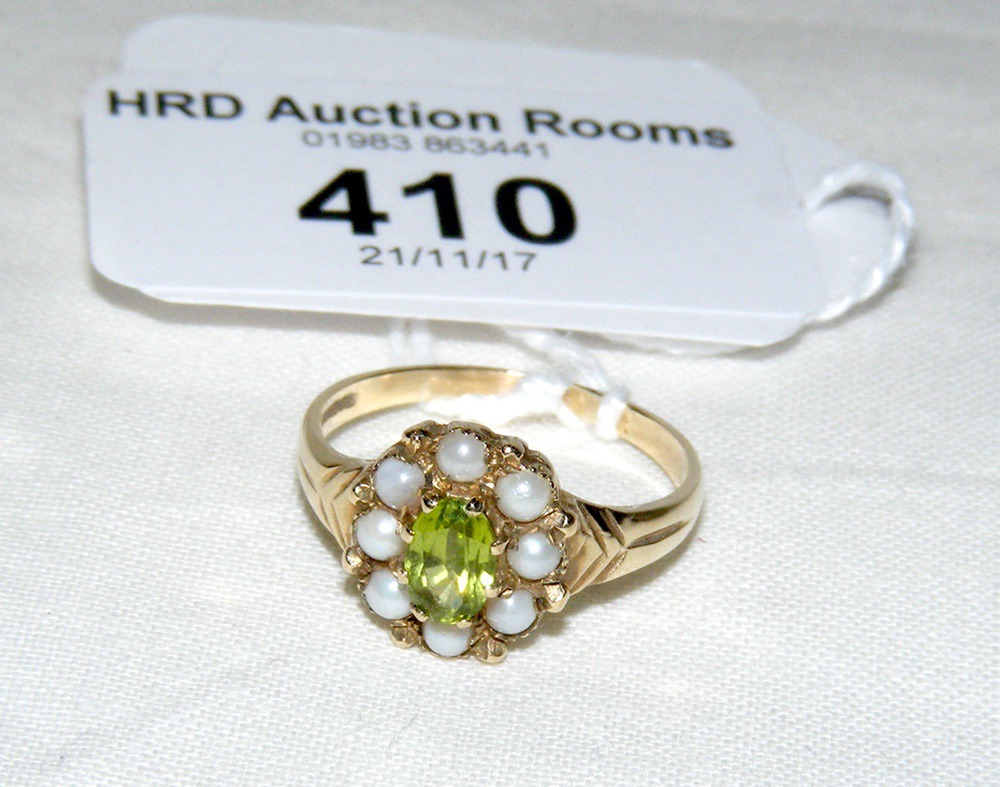 A peridot? and seed pearl ring in gold setting