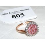 A pink sapphire and diamond cluster ring in 9ct gold setting