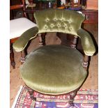 A Victorian tub chair with button back and turned front supports