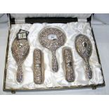 A five piece silver back dressing table set in presentation case