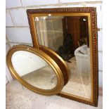 An oval wall mirror, a bevelled wall mirror, together with a small kitchen table
