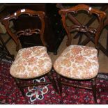 A pair of rosewood bedroom chairs with shaped backrests