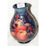 A Moorcroft pottery vase with grape, fruit and bird decoration - 20cm high - with mark to base