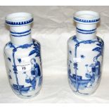 A pair of antique blue and white vases with Chien Lung mark to base - 25cm high
