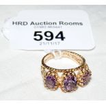 A three stone amethyst ring in 9ct gold setting