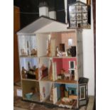 A large old doll's house with extensive doll's house furniture - 120cm high