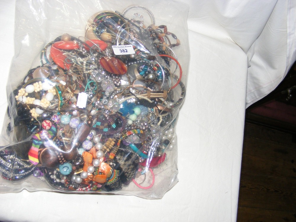 A large bag of costume jewellery, including bangles and necklaces