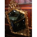 A decorative gilt framed wall mirror - 145cm x 80cm