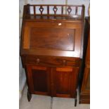 A mahogany student's bureau with cupboard below