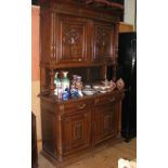 A French carved oak sideboard with panelled doors to the top, drawers and cupboards below - 140cm