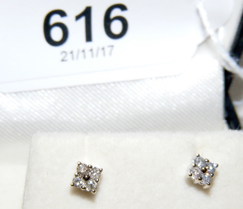 A pair of diamond stud earrings in 9ct gold setting