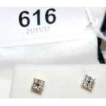 A pair of diamond stud earrings in 9ct gold setting