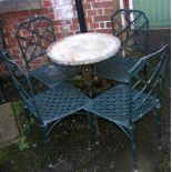 A heavy metal circular garden table and four chairs