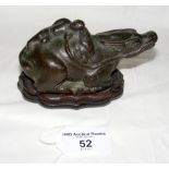 A bronze Chinese water dropper in the form of a Water Buffalo with a figure at rest on its back,