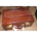 An Alligator skin suitcase by Varma Limited of Deli