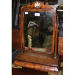 An antique walnut toilet mirror with two drawers to the base