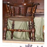 An antique Captain's chair on turned supports