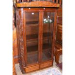 A carved oriental two door display cabinet with two drawers to the base - 164cm high x 90cm wide