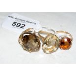 A gold smoky quartz style dress ring and two others