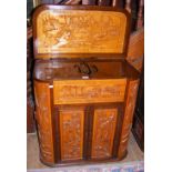 A carved oriental cocktail cabinet - 78cm wide - with fitted interior