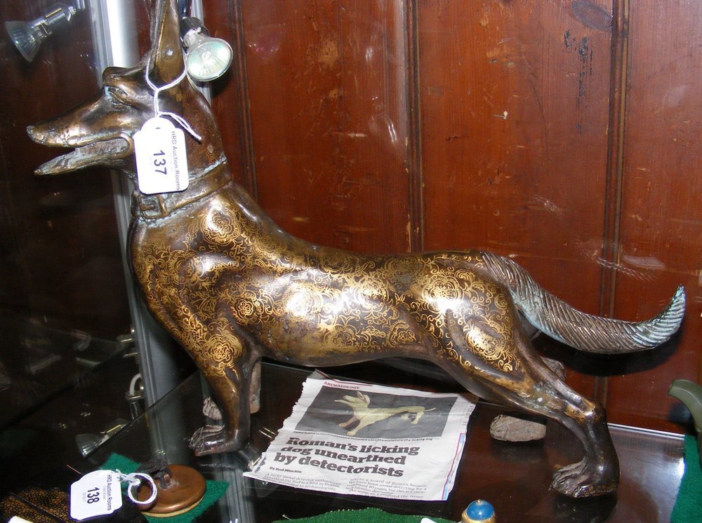An unusual bronze sculpture of licking dog with gilt decoration - 40cm long