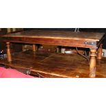A hardwood rectangular coffee table on turned supports