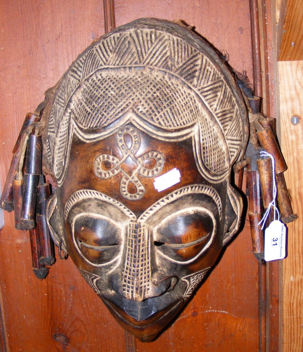 A carved wooden African tribal mask - 36cm