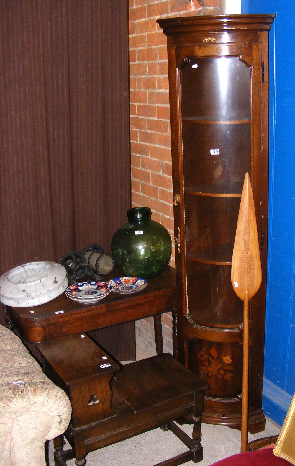 A 19th century fold-over table on turned supports, together with an inlaid corner cabinet and oak